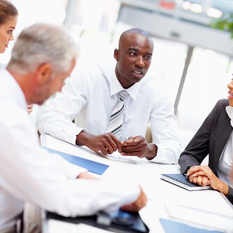 business-commercial-insurance people sitting around a table in an office
