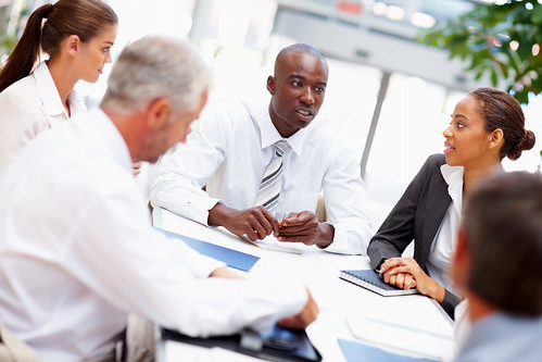 people sitting around a table in an office